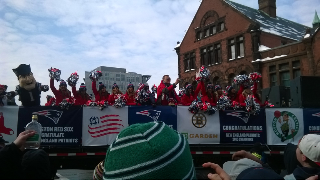 Patriots cheerleaders lead the team's way to City Hall Plaza from Prudential Tower.