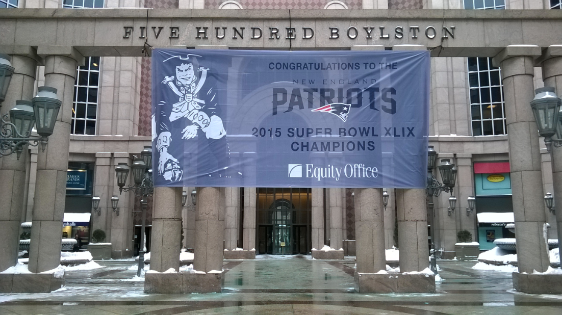 A sign congratulating the Patriots hangs at 500 Boylston Street.