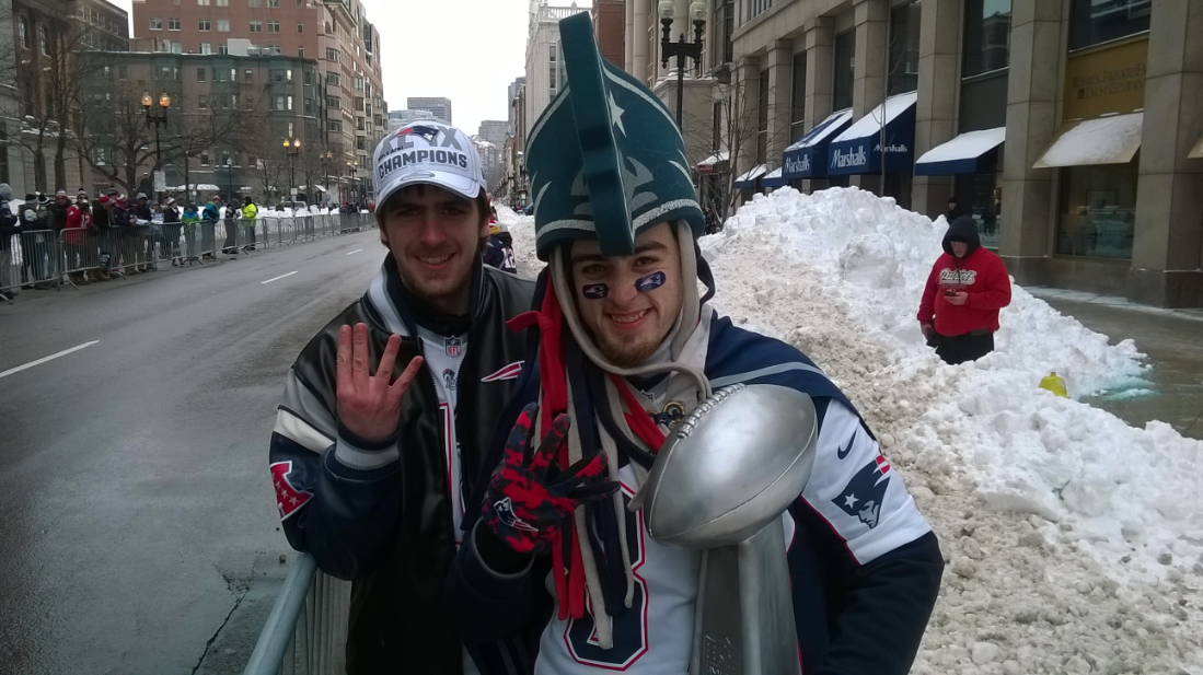 Patriots fans hold up four fingers each, representing the team's four Super Bowl championships since 2001.